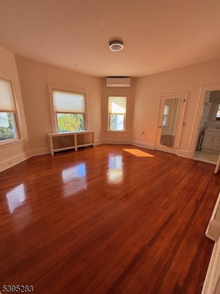 252 Highwood Avenue Ridgewood, NJ 07450 - Photo 16 of 20 an empty room with wooden floor and windows