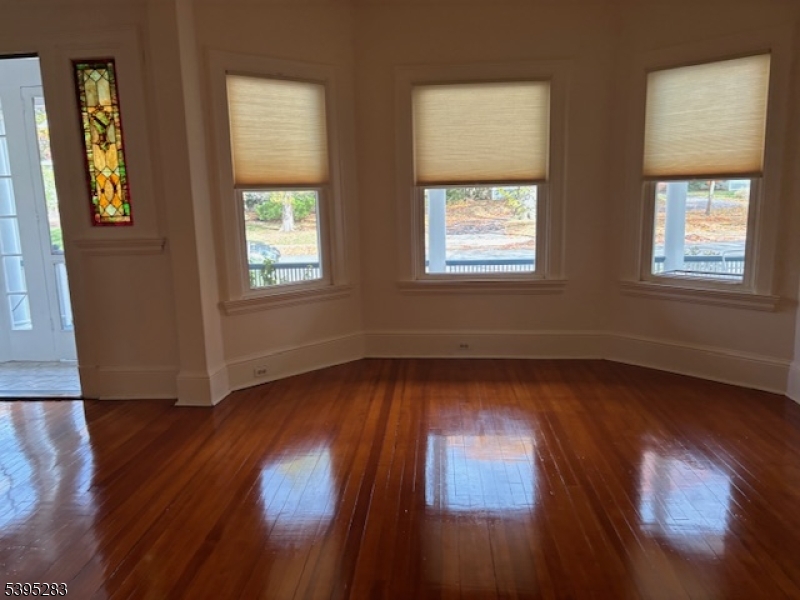 252 Highwood Avenue Ridgewood, NJ 07450 - Photo 5 of 20 a view of an empty room with wooden floor and a window