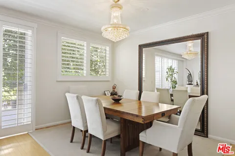 a kitchen with stainless steel appliances granite countertop a stove a sink and a window