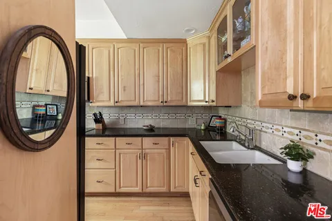 a kitchen with stainless steel appliances granite countertop white cabinets a sink and dishwasher