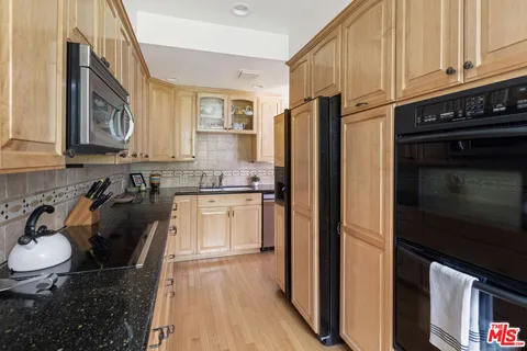 a kitchen with a sink stove and microwave