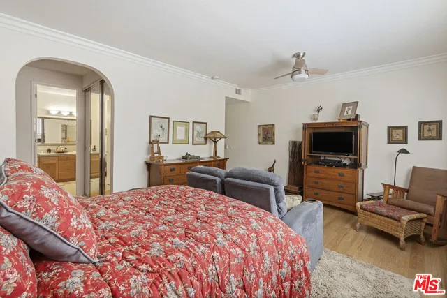 a living room with a bed and a mirror