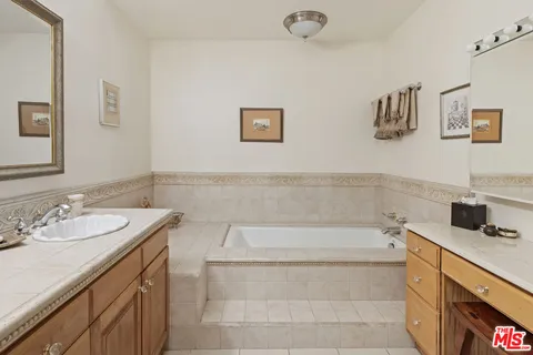 a spacious bathroom with a shower sink and mirror