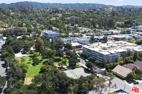 a view of a street with large trees
