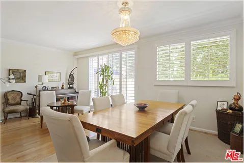 a dining room with furniture a rug and a chandelier