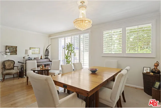 a dining room with furniture a rug and a chandelier