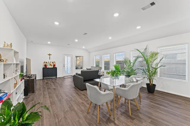 a view of a dining room with furniture window and wooden floor