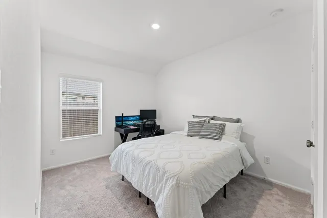 a bedroom with two beds and a window