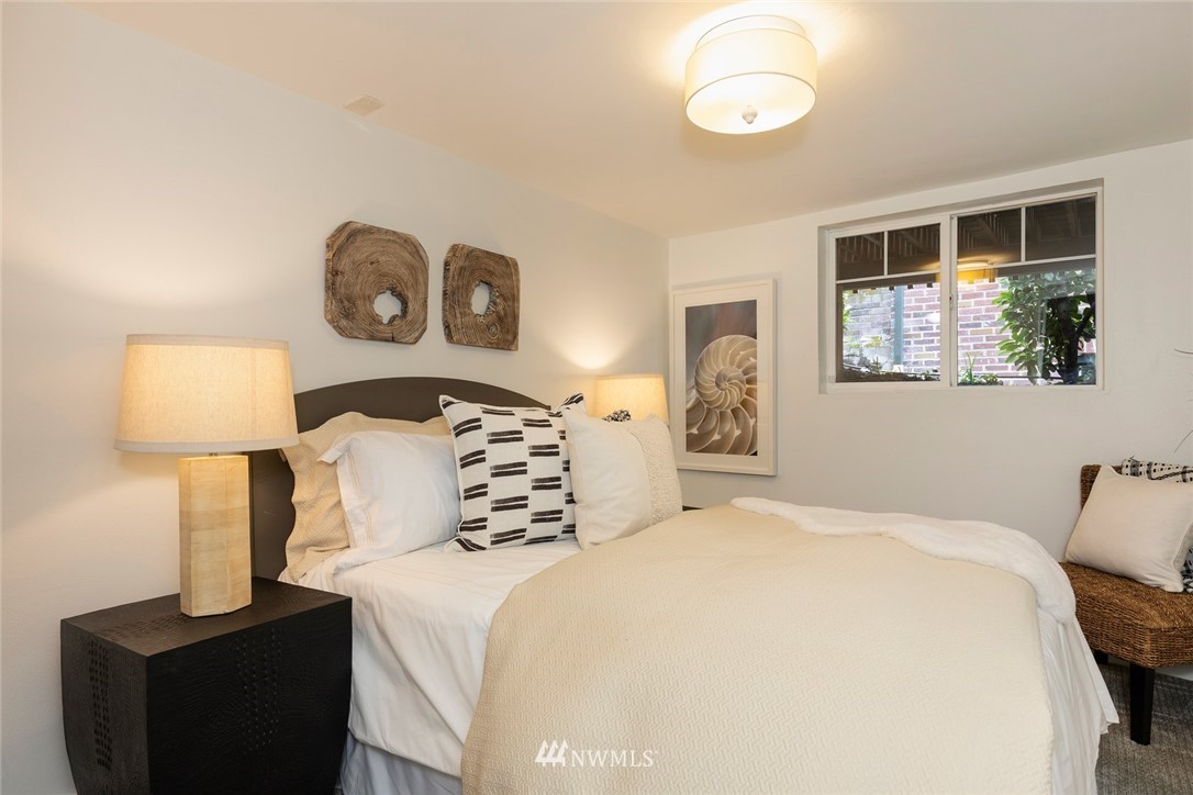 2409 30th Avenue West Seattle, WA 98199 - Photo 23 of 38 a bedroom with a bed and a lamp