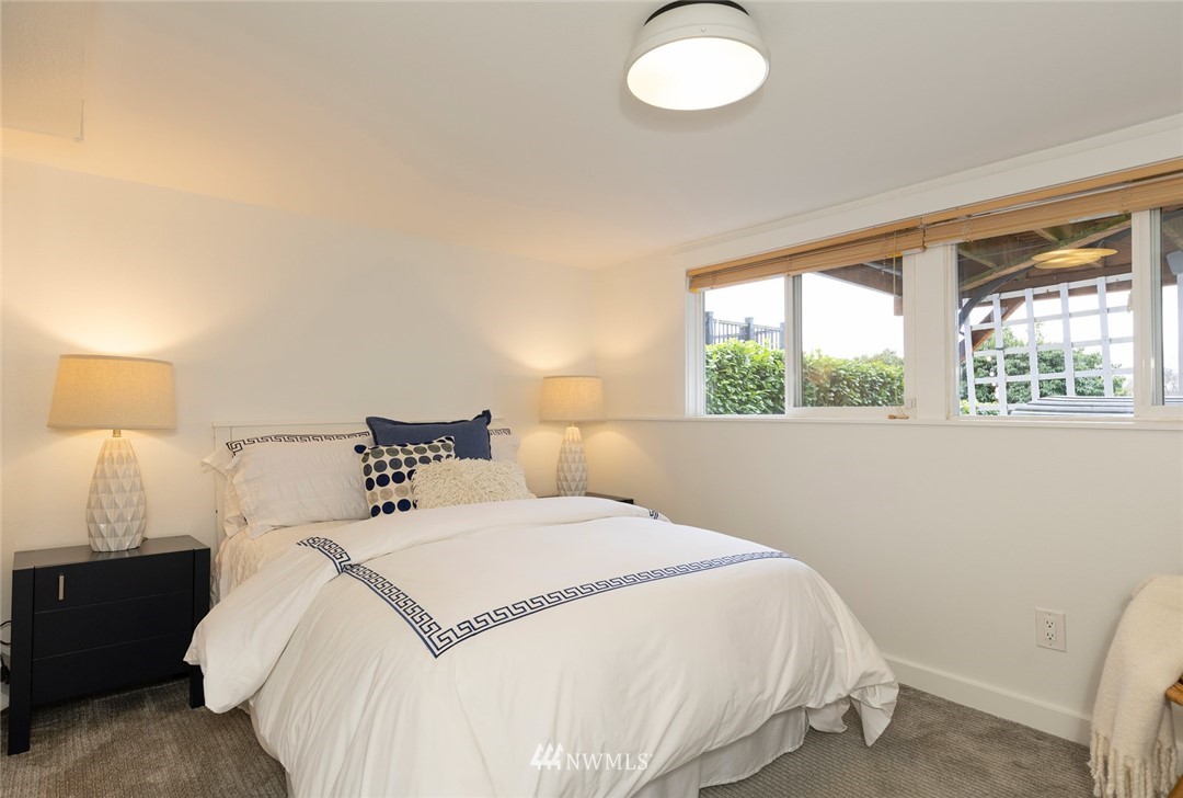 2409 30th Avenue West Seattle, WA 98199 - Photo 24 of 38 a bedroom with a bed and a lamp