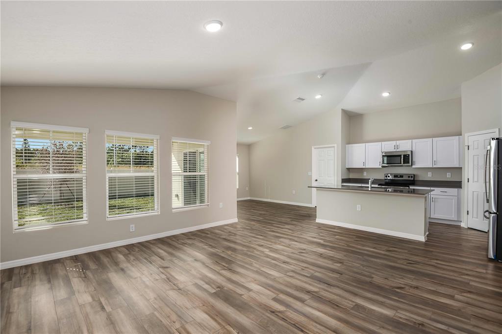 1338 Palmeroy Road Haines City, FL 33844 - Photo 11 of 32 a view of kitchen with kitchen island granite countertop a stove top oven a sink and a granite counter top