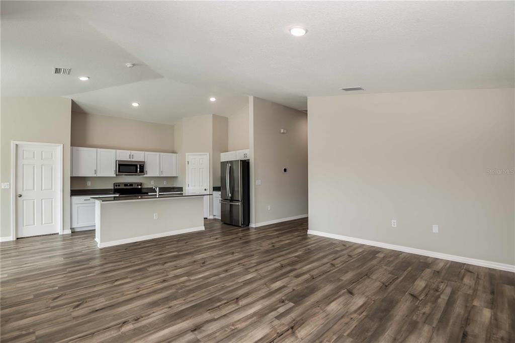 1338 Palmeroy Road Haines City, FL 33844 - Photo 12 of 32 a view of kitchen with stainless steel appliances wooden floor and large window