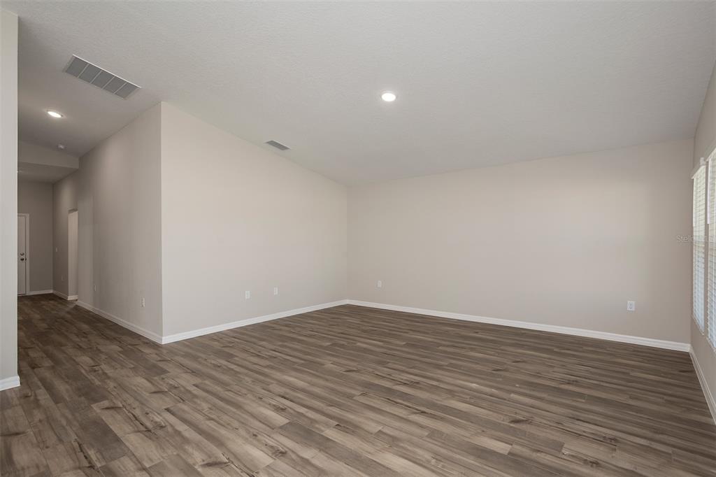 1338 Palmeroy Road Haines City, FL 33844 - Photo 15 of 32 a view of an empty room with wooden floor