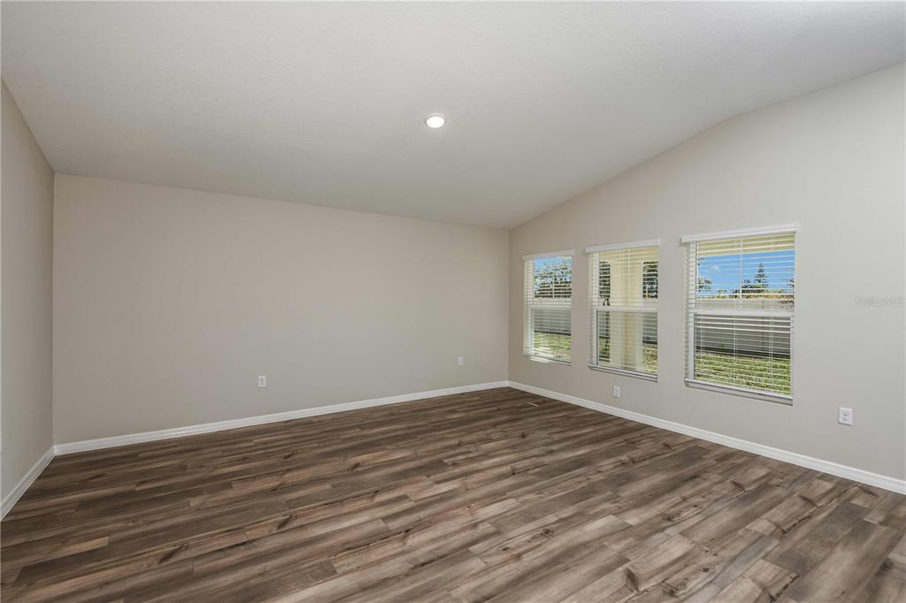 1338 Palmeroy Road Haines City, FL 33844 - Photo 17 of 32 a view of empty room with wooden floor and fan