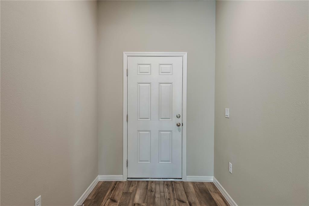 1338 Palmeroy Road Haines City, FL 33844 - Photo 29 of 32 a view of front door with wooden floor