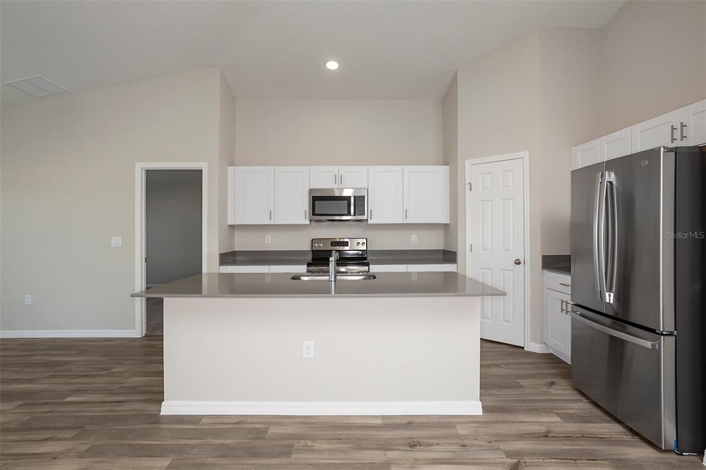 1338 Palmeroy Road Haines City, FL 33844 - Photo 6 of 32 a kitchen with a refrigerator and a sink