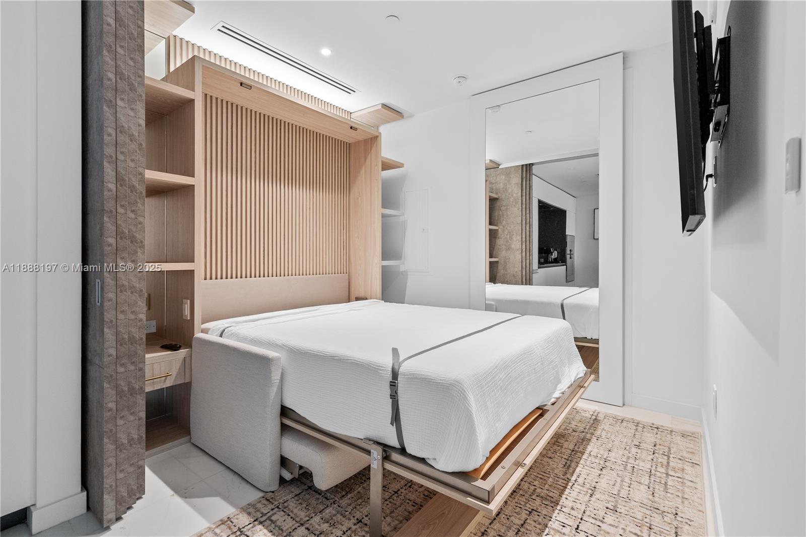 300 Biscayne Blvd Way, Unit 1103 Miami, FL 33131 - Photo 8 of 47 a bedroom with a bed and a mirror