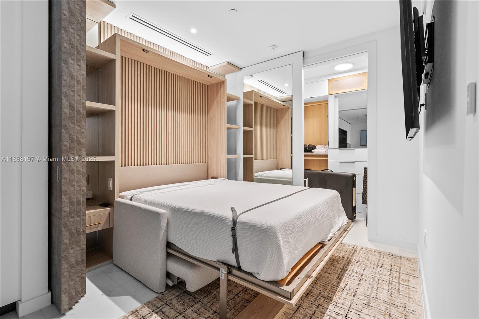 300 Biscayne Blvd Way, Unit 1103 Miami, FL 33131 - Photo 9 of 47 a bedroom with a bed and a mirror