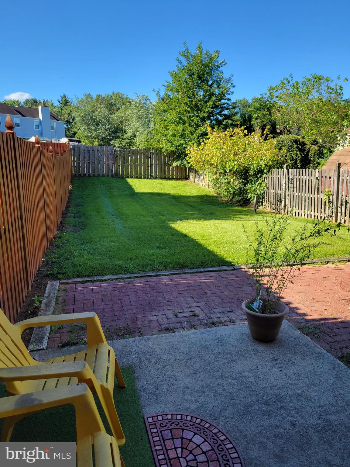 a view of a backyard with wooden fence
