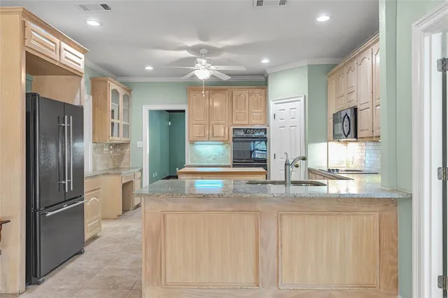 a kitchen with kitchen island white cabinets and stainless steel appliances