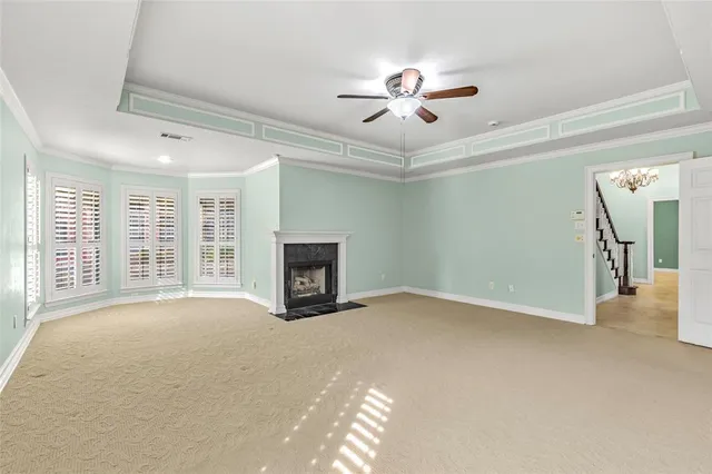 a view of an empty room with a fireplace and a window