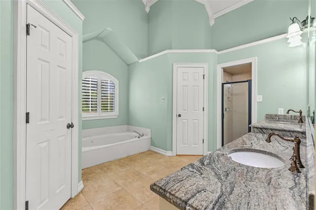 a bathroom with a tub sink and mirror