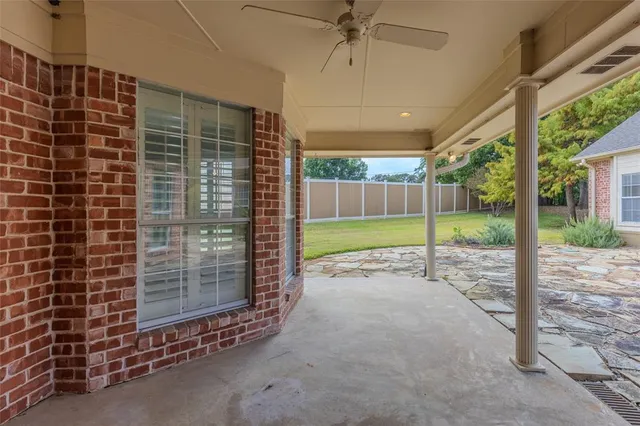 a view of an empty room with floor to ceiling windows