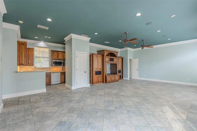 a view of an empty room with closet and windows