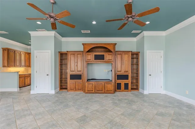 a view of a livingroom with a furniture ceiling fan and window