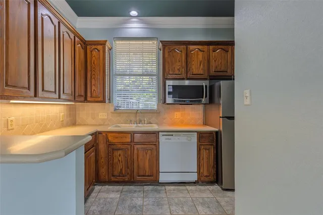 a kitchen with a sink and a microwave