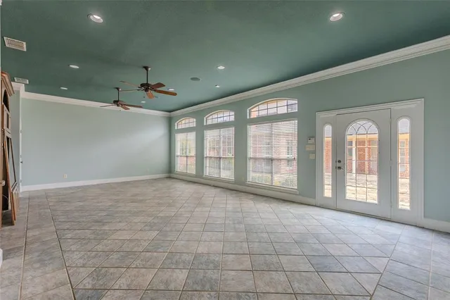 a view of an empty room with a fireplace and a window