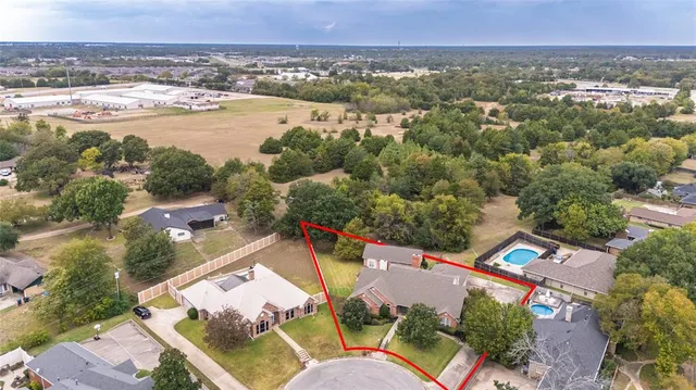 an aerial view of a house with a lake view