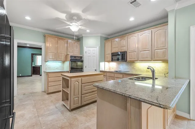 a kitchen with stainless steel appliances granite countertop a sink stove and cabinets