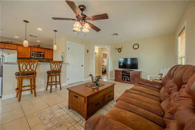 a living room with furniture and a dining table
