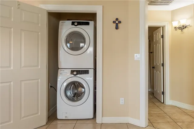 a view of a hallway with wooden floor and a bathroom