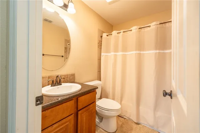 a view of a house with wooden fence
