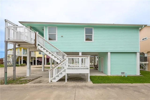 a view of a house with wooden fence