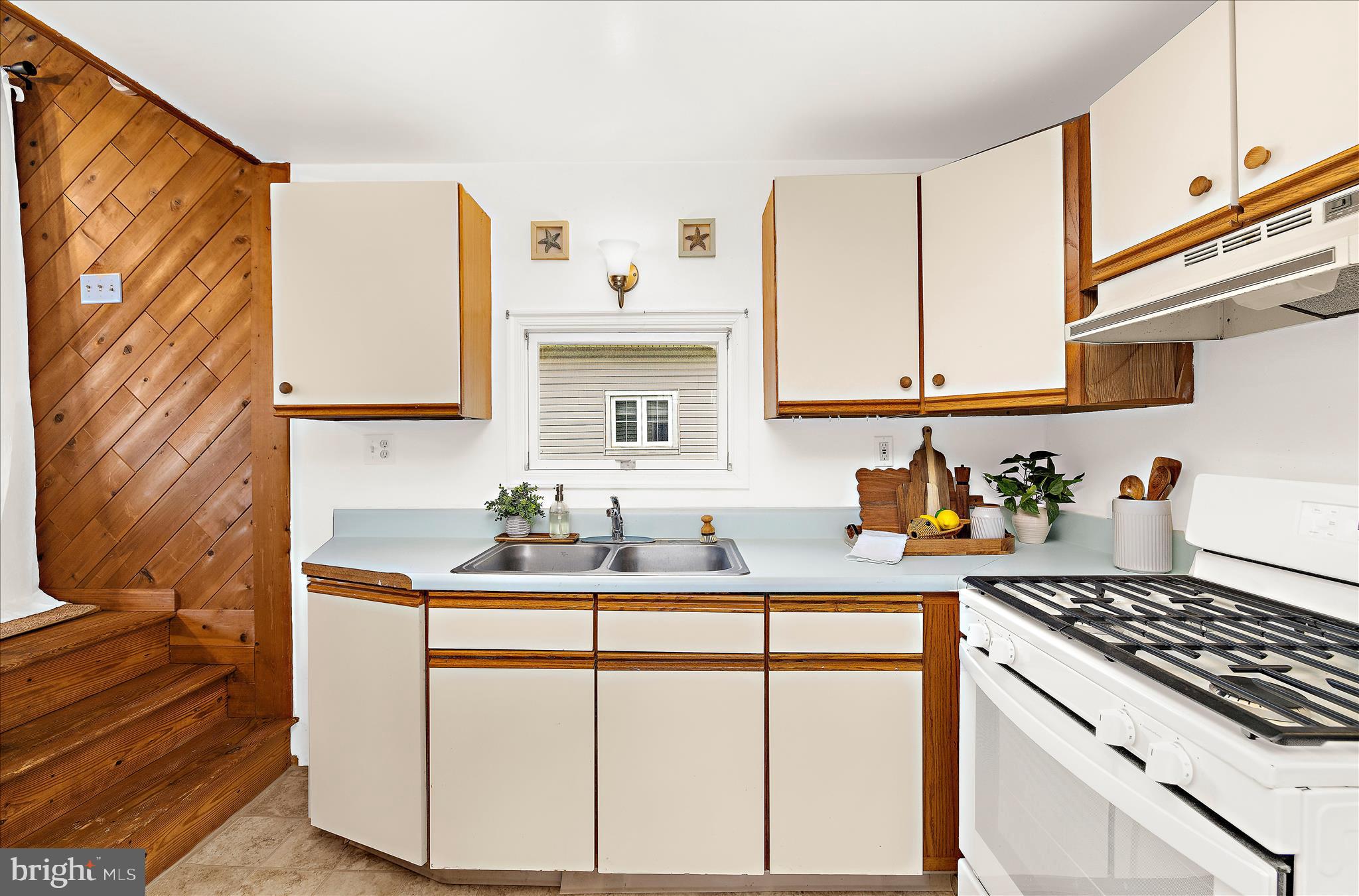 25 Locust Street Earleville, MD 21919 - Photo 17 of 64 a kitchen with granite countertop a sink stove and cabinets