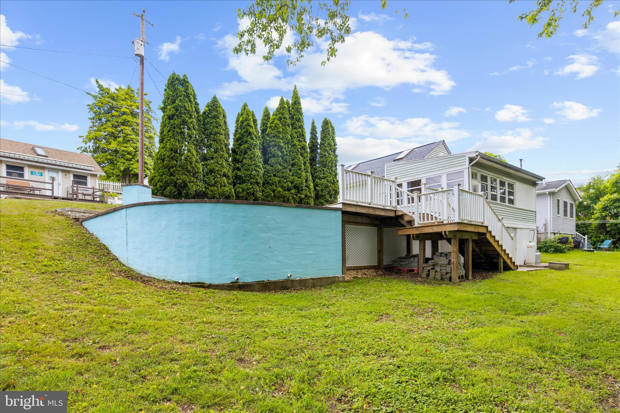 25 Locust Street Earleville, MD 21919 - Photo 41 of 64 a view of a swimming pool with lawn chairs and a yard