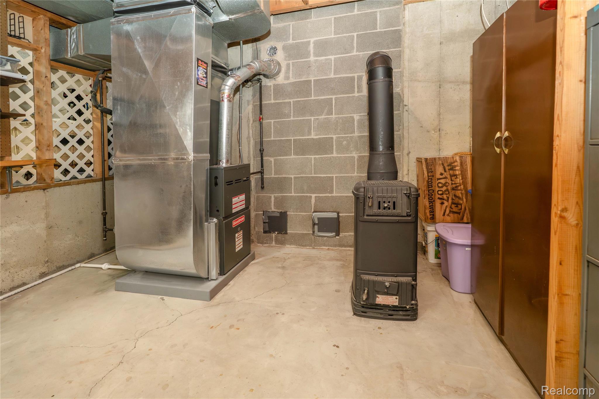 2725 Cooley Lake Road Highland, MI 48356 - Photo 52 of 67 Furnace and functional wood burning fireplace