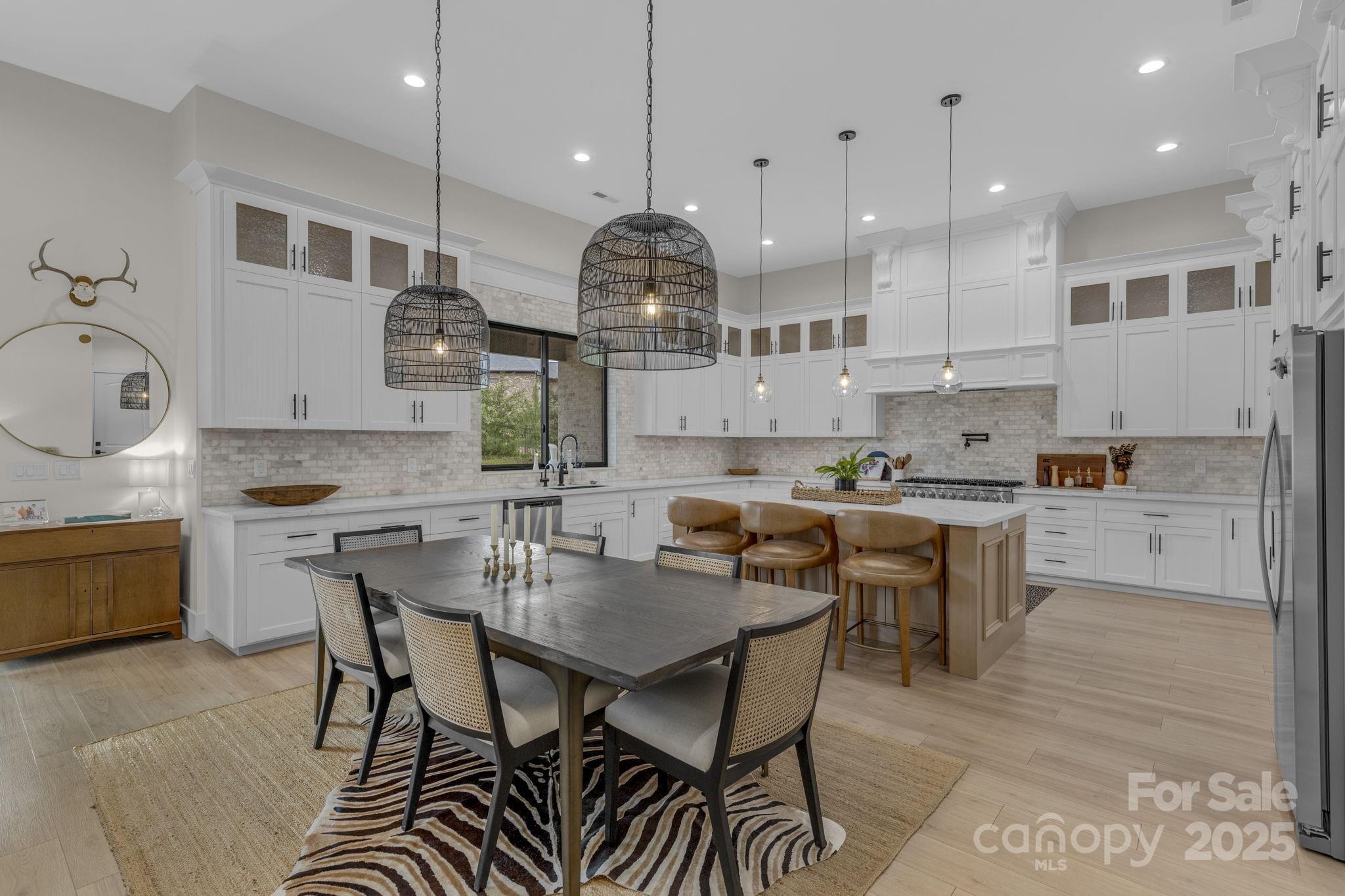 416 World Tour Drive Inman, SC 29349 - Photo 13 of 45 a kitchen with stainless steel appliances granite countertop a stove a sink a kitchen island with a dining table and chairs