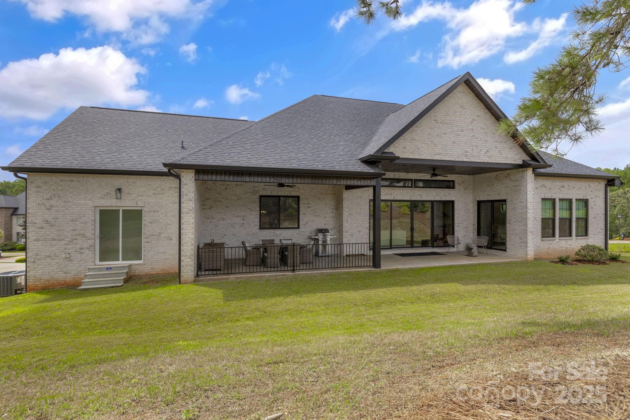 416 World Tour Drive Inman, SC 29349 - Photo 34 of 45 a front view of a house with a garden and patio