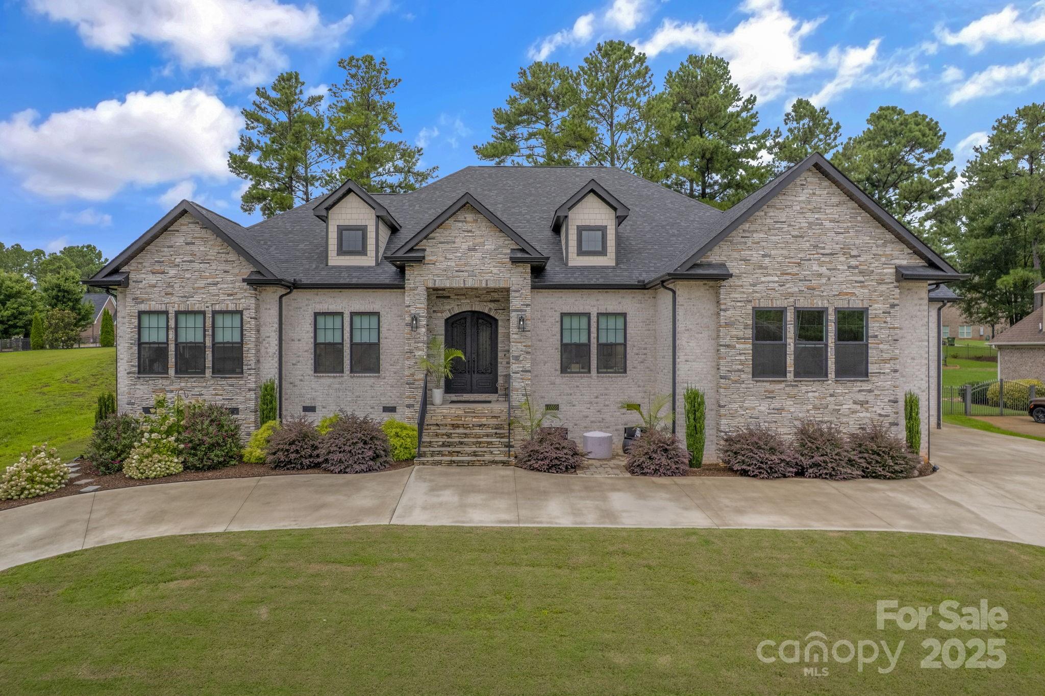 416 World Tour Drive Inman, SC 29349 - Photo 4 of 45 a front view of a house with plants and garden