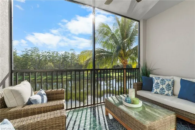 a balcony with furniture and a potted plant
