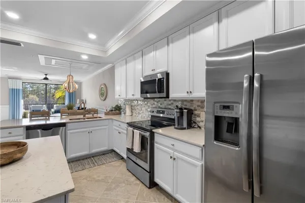 a kitchen with a sink stainless steel appliances and cabinets