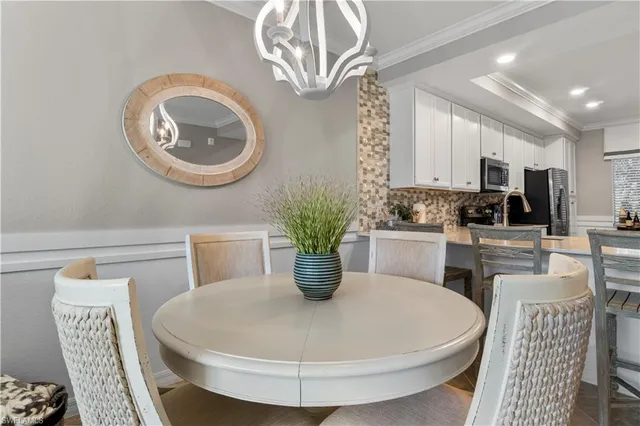 a kitchen with a stove a sink and a dining table