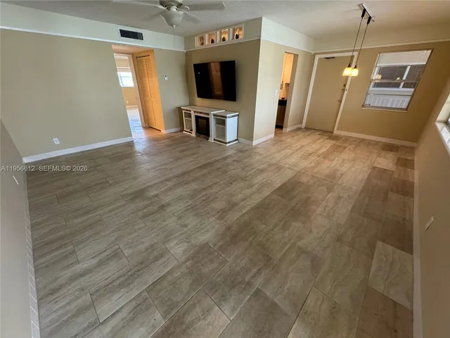 a view of a livingroom with an empty space and a flat screen tv