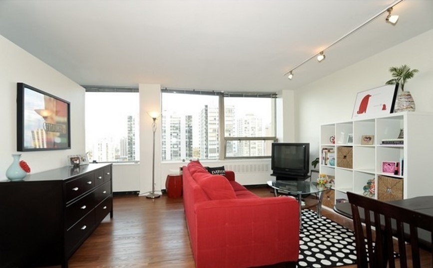 Undisclosed Address Chicago, IL 60610 - Photo 2 of 8 a living room with furniture a flat screen tv and a floor to ceiling window