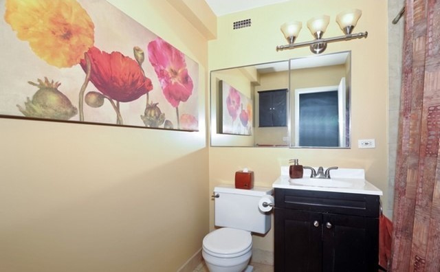 Undisclosed Address Chicago, IL 60610 - Photo 7 of 8 a bathroom with a sink vanity mirror and toilet