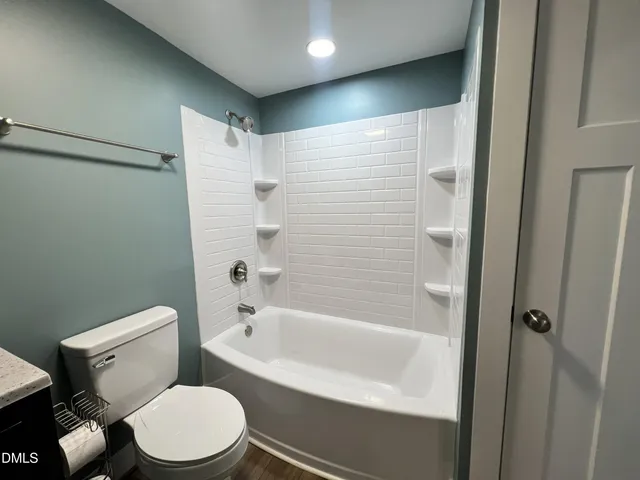 a spacious bathroom with a bathtub shower sink and toilet